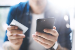 Hands with smartphone and credit card