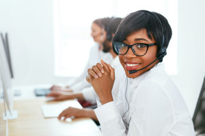 Call Center Operator With Colleagues At Workplace