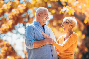 Active seniors on a walk in autumn forest